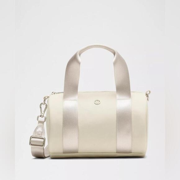 lululemon athletica Handbags - 🆕🤍 Lululemon Knit Nylon Mini Barrel Duffle Bag - Raw Linen
